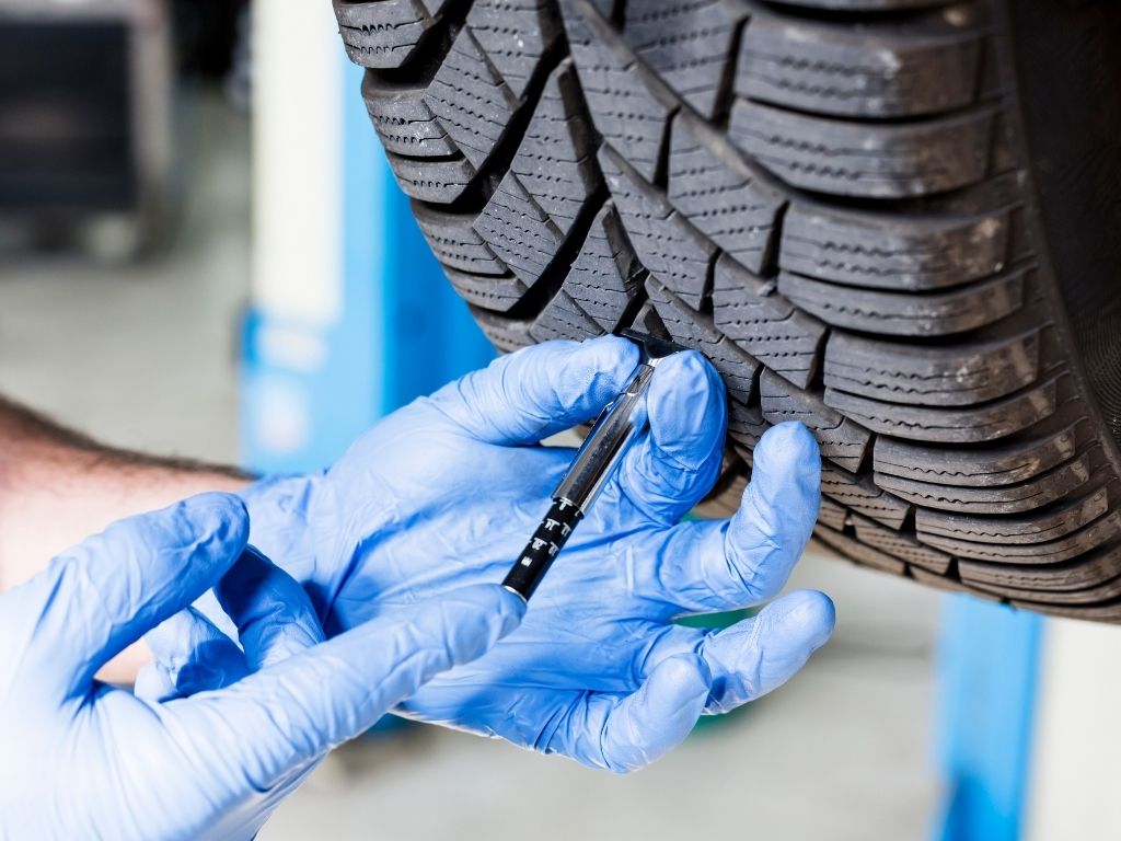 Assess tire treads excessive wear tear